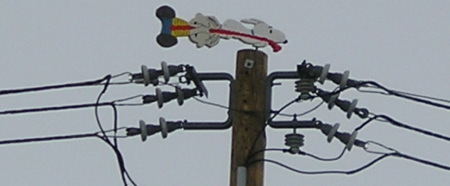 wires, a pole and a weathervane